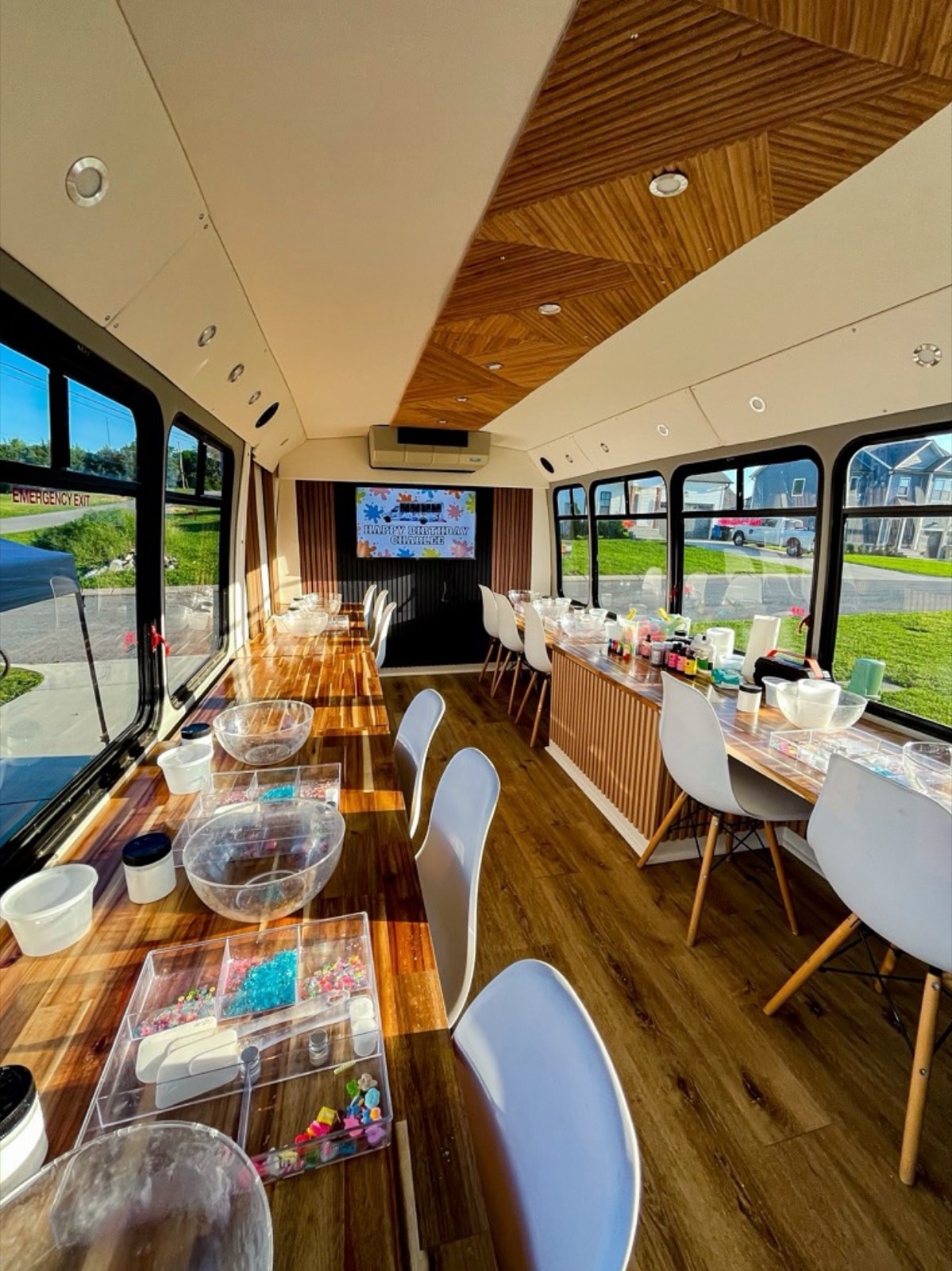 Inside the Kids as Creatives mobile studio bus, set up with craft stations
